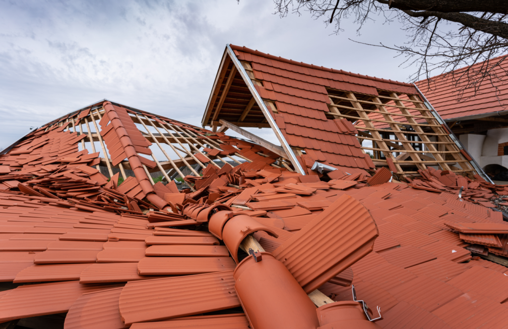 Hurricane damaged roof and house.png